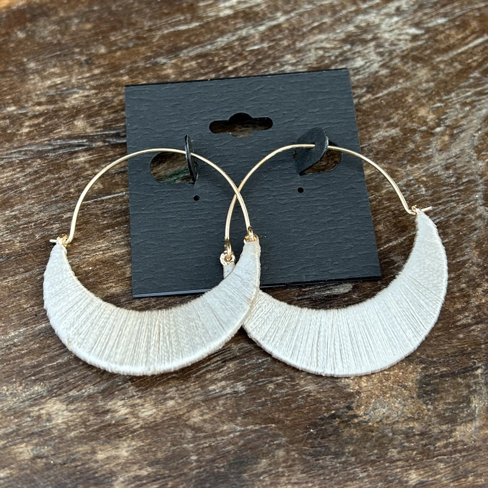 Add a touch of elegance to any outfit with our Wrapped Hoop Earrings. These delicate hoops are wrapped in silky string, creating a modern yet lovely look. What a beautiful style!
