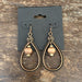 Experience elegance with our Bronze Metal Teardrop Earrings. The beautiful bronze color, ornate design, and teardrop shape with stone center beads create a unique and classy look that will enhance any outfit.