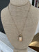Add a touch of elegance to any outfit with our Gold Necklace w/ Stone Pendant! This chain necklace with interspersed gold beads features a stunning colored stone pendant, making it the perfect statement piece for any occasion – dressy or casual.  Approximate length: 18-21"