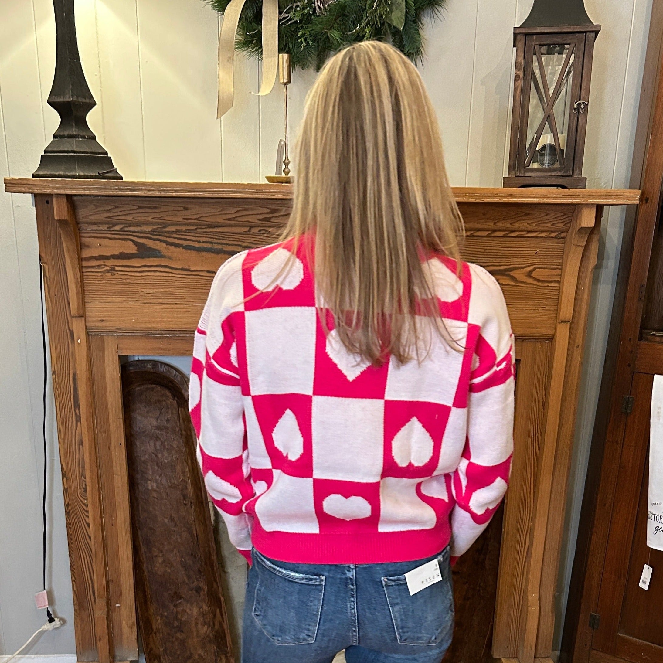 Back view of color block heart print sweater.