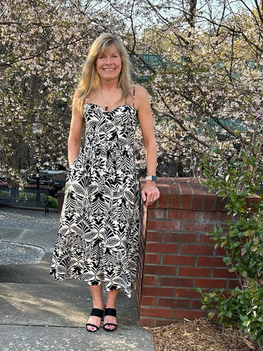 <p>Transform your wardrobe with our stunning Printed Midi Dress. With a gorgeous black and cream print, ruffle hem, and wired cups for the perfect fit, this lined dress is both stylish and adjustable with its waist tie and smocked back. Dress it up or down by pairing it with your favorite white denim jacket.&nbsp;</p> <p>Material: 89.3% Viscose / 10.7% Nylon</p> <p>Care Instructions: Dry Clean</p>