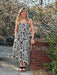 <p>Transform your wardrobe with our stunning Printed Midi Dress. With a gorgeous black and cream print, ruffle hem, and wired cups for the perfect fit, this lined dress is both stylish and adjustable with its waist tie and smocked back. Dress it up or down by pairing it with your favorite white denim jacket.&nbsp;</p> <p>Material: 89.3% Viscose / 10.7% Nylon</p> <p>Care Instructions: Dry Clean</p>
