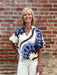 This Abstract Print Top is designed for those who appreciate artistic expression in their everyday wardrobe. Set against a soft cream canvas, the bold abstract print commands attention while remaining effortlessly wearable. Puff sleeves add a touch of romance and dimension, while the V-neck with placket collar keeps the look modern and refined. Style it with coordinating cream pants for a cohesive, polished appearance, or pair with denim for an approachable, laid-back vibe. A versatile piece that transition