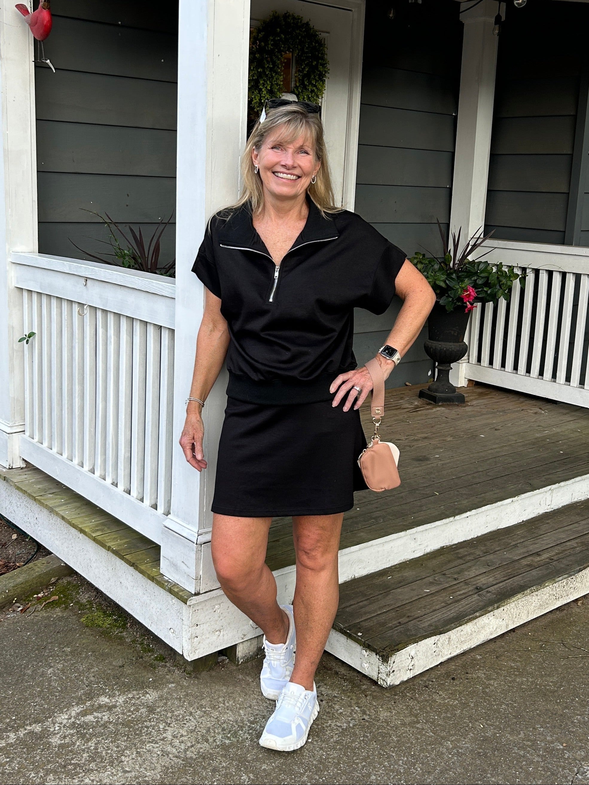 Experience the perfect blend of comfort and functionality with this scuba knit skort. Made from luxuriously soft fabric, it delivers the coverage and ease you need for everything from casual outings to active pursuits. We love the flattering length, the comfortable fit, and the built in short. It pairs perfectly with our quarter zip top for an effortless coordinated look. Your new go-to in classic black.

Carolee is wearing a Small.&nbsp; She paired it with our matching "Scuba Knit Quarter Zip Top".

Materi