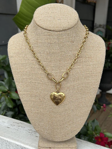 This stunning Chunky Chain w/ Hammered Heart Pendant is the perfect addition to any outfit with its beautiful gold color. The prominent heart pendant adds a touch of elegance and the clasp closure ensures a secure fit. Complete your look with this lovely accessory.  Designed and made by local artist Approximate measurement: 18"