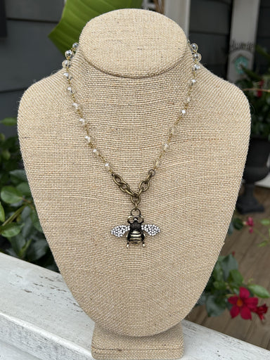 This lovely Crystal Beaded Chain with Ornate Bee Pendant features a beautiful combination of crystal and gold, creating a mesmerizing and eye-catching piece. The exquisite rhinestone and gold bee pendant adds a touch of elegance and charm. With a secure clasp closure, this necklace is the perfect accessory for any occasion.  Designed and made by local artist