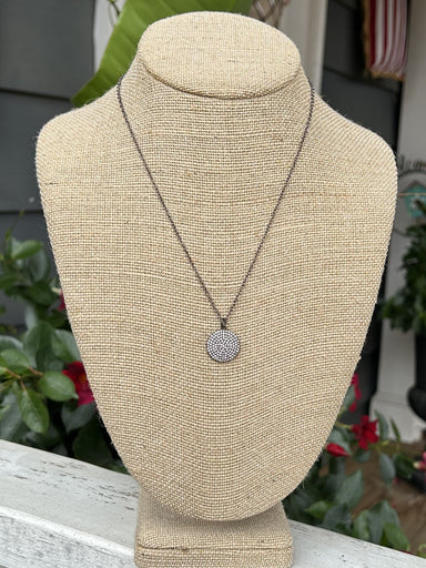 This stunning gunmetal necklace boasts a round crystal pendant for a touch of elegance. The simple design is perfect for any occasion, making it a versatile and timeless addition to your jewelry collection.&nbsp;  Designed and made by local artist Measurements: 18"