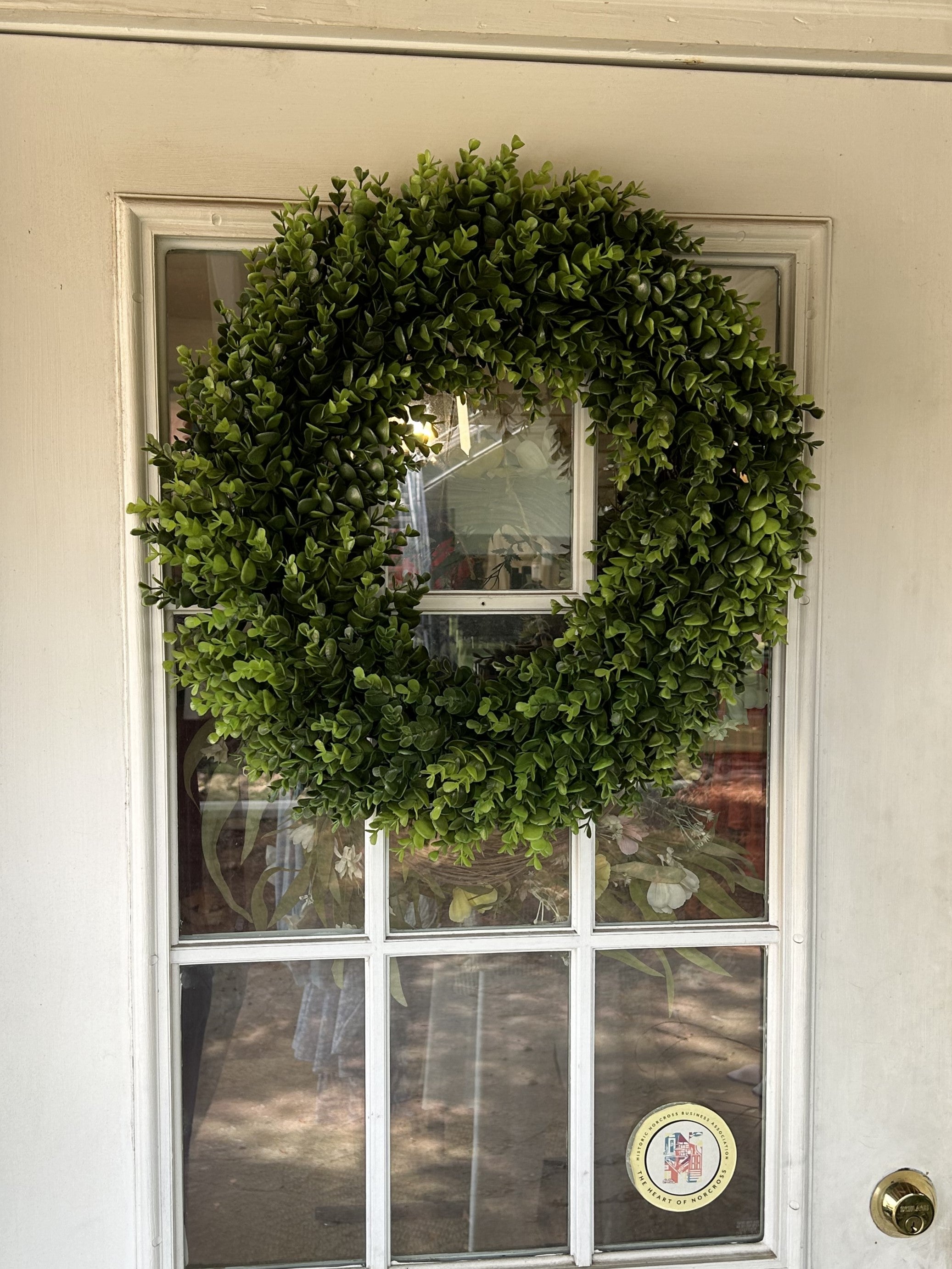 Add a touch of nature to your home with our 20" Boxwood Wreath! Crafted from high-quality artificial grapevine and plastic, it offers a natural look without the maintenance. Its 22-inch diameter makes it a stunning addition to any indoor space or covered porch area.  Sashes are not included but you can add our beautiful wreath sashes to your boxwood wreath to celebrate game day or different seasons of the year!