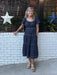 Casual meets game-day style in this smocked-waist tiered midi dress. The navy silhouette features contrasting stitching and a flattering tiered skirt that moves beautifully. The fabric is soft and comfortable. Short sleeves keep it casual and comfortable, while the defined waist creates a polished shape. Layer with a jacket to take it further into fall.&nbsp;

Carolee is wearing a small. She paired it with sandals and boots.

Material: 100% Cotton

Care Instructions: Hand wash with cold water, hang dry