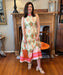 Beautiful maxi halter dress with a tiered skirt in a santa fe print. It has a cream backtground with green pink and orange print. The fabric is lovely and travels well.
