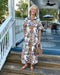 Timeless florals meet everyday comfort in this cream button-up midi dress. The charming blue and brown floral print pairs beautifully with a polished collared neckline and placket front detail. Lightweight, fully lined fabric ensures all-day comfort and confidence, while short sleeves and a relaxed straight cut make it effortlessly versatile. Whether you're running errands or enjoying warm-weather gatherings, this dress transitions seamlessly from casual to put-together.

Material: 100% Cotton

Care Instruc