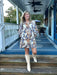 This dress will be a fall fav! We love this print so much we had to carry it in two styles! The short version features the soft cream background with blue and brown floral accents with a flattering V-neckline and three-quarter sleeves offer a polished silhouette. It is fully lined for a smooth fit and refined feel and looks great with tall boots, booties or flats.&nbsp;

Carolee is wearing a small.&nbsp;

Material: 100% Cotton

Care Instructions: Hand wash in cold, line dry