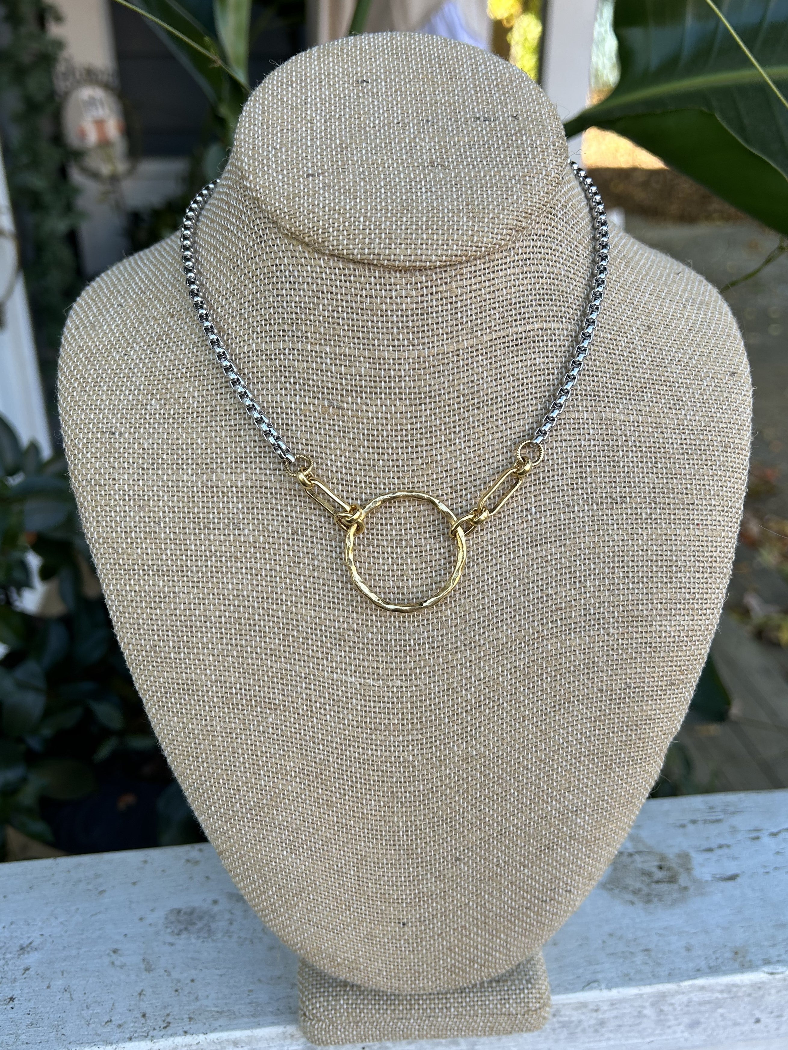 Add a touch of elegance to any outfit with our Mixed Metal Necklace featuring a stunning hammered pendant. The combination of small silver chain links and long gold links creates a unique and versatile piece that can be paired with both silver and gold jewelry.

14-15" in length