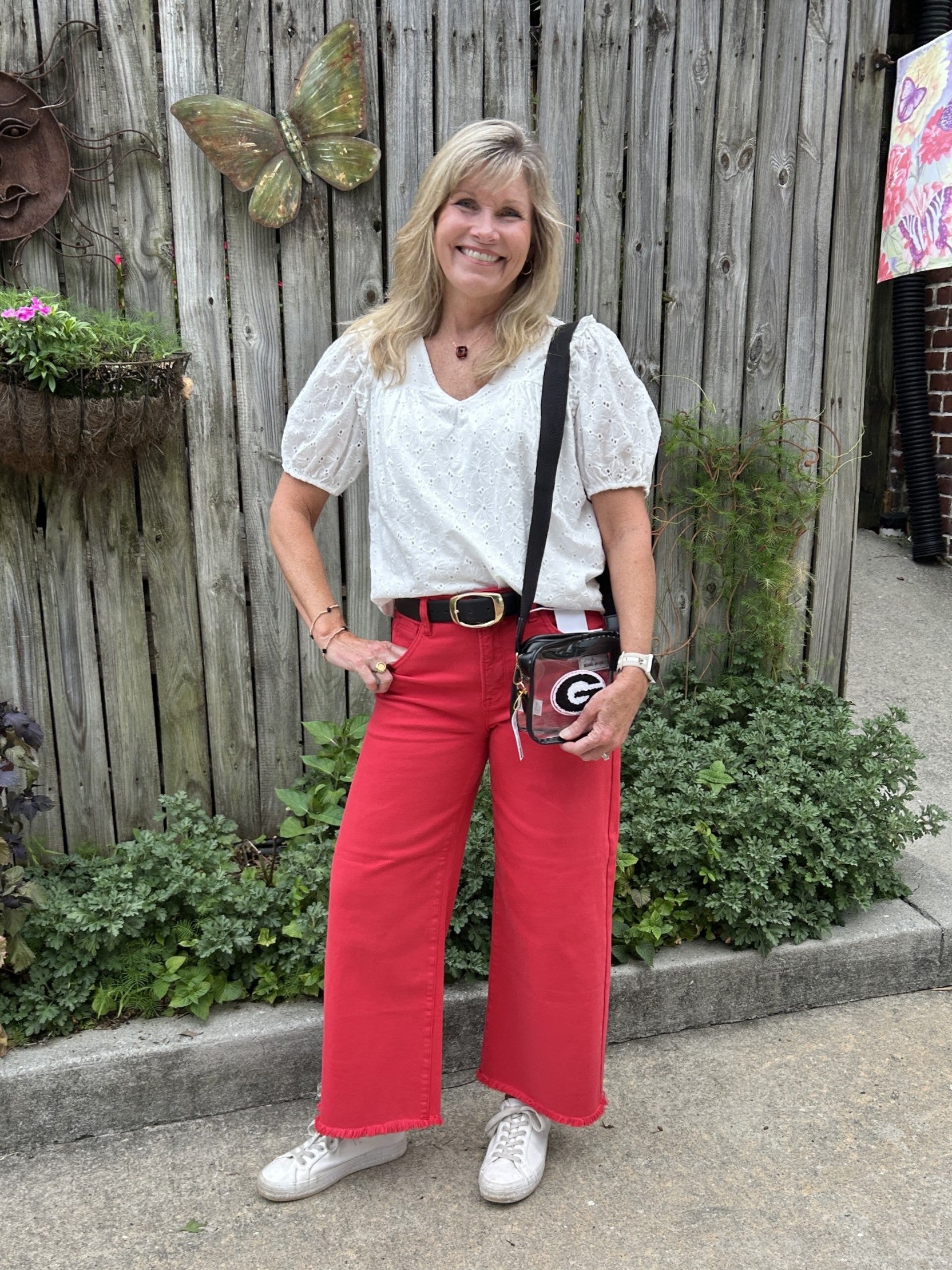 Be ready on game day with our Risen High Rise-Crop Wide Pants in vibrant scarlet red. These cropped, high-rise pants feature a wide-leg design and a stylish frayed hem for a casual yet bold look. Comfortable and easy to wear, they’re perfect for staying relaxed while showcasing your spirited style.

Carolee paired them with our Eyelet Puffed Sleeve Top, Clear Georgia "G" Game Day Bag, and Collegiate Initial Necklaces ("G).

Material: 98% Cotton / 2% Spandex

Care Instructions: Machine wash cold, hang to dry