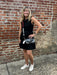 This black sleeveless mini dress offers a flattering silhouette that effortlessly enhances your figure. Perfectly lined for comfort, it features convenient side pockets to keep essentials close. Whether you're gearing up for game day or planning a stylish evening out, this dress combines practicality with chic appeal to keep you looking and feeling confident.

Carolee is wearing a size Small. She has accessorized with our Gold Beaded Necklace w/ Small Crosses (red), Bag/Purse Straps: Game Day Beaded (GO DAW