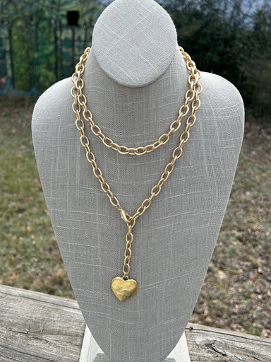 Transform your look with our Heart Wrap Necklace! Made with a gold chunky chain and a stunning heart pendant, you can wrap the chain to wear it long or shorter. The front clasp closure adds convenience and the unique design is sure to make a statement.&nbsp;

Approximate length: 36"

Made by&nbsp; jewelry designer and artist Kelli Smith, part of her Novel line of jewelry.
Learn about her eclectic, vintage designs. She finds vintage pieces and turns them into beautiful and unique pieces of jewelry. Take home