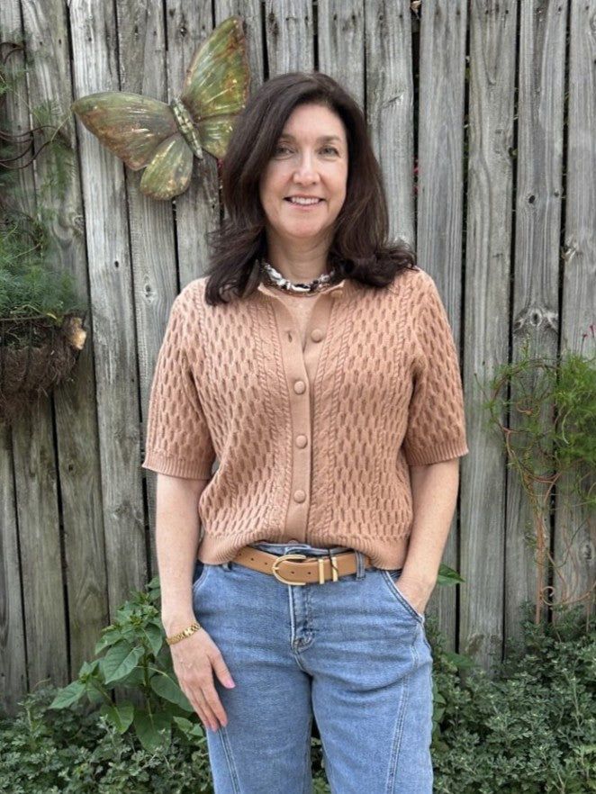 This Short Sleeve Button Up Knit Top in a rich camel hue features a textured weave that adds stylish depth. Crafted from soft, cozy fabric, it offers a comfortable fit all day long. The button-up front and short sleeves make it an easy layering piece or a standalone staple for effortless, polished looks.

Material: 43% Viscose / 32% Nylon / 25% Polyester

Care Instructions: Gentle cool hand wash, dry flat