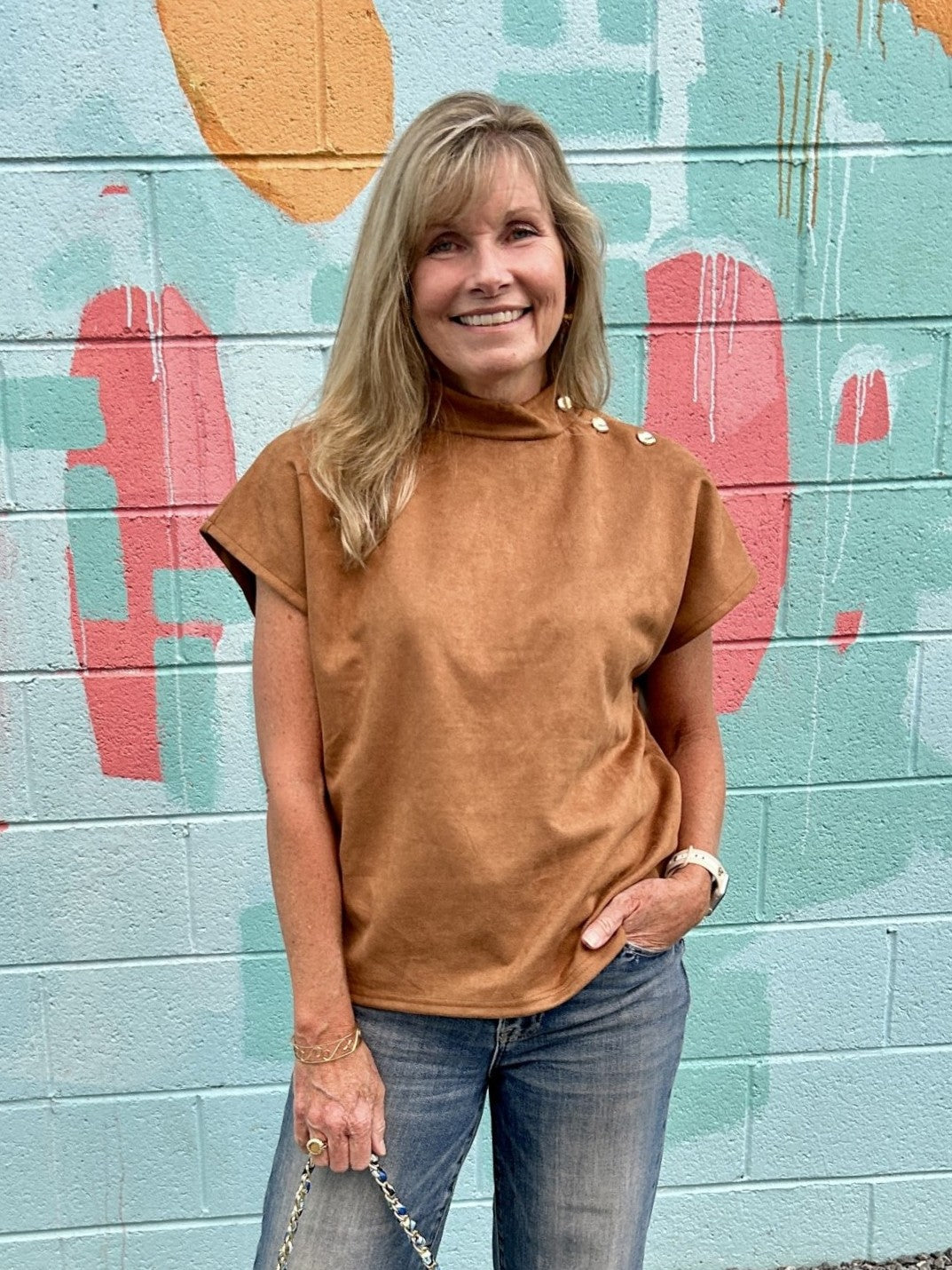 This short sleeve suede top in a beautiful camel color is perfect through the season. Its cap sleeves and shoulder button accents add subtle style details, making it a versatile transition piece for your wardrobe. Wear it alone or add layers as needed.

Material: 94% Polyester / 6% Spandex

Care Instructions: Gentle cool hand wash, dry flat