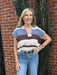 This lightweight Striped Cap Sleeve Sweater in a stunning frosted mocha color blends comfort and style effortlessly. Featuring a chic color block and striped design, it adds a modern touch to any outfit. The cap sleeves provide a delicate, flattering fit, making it an ideal layering piece. Perfect for transitioning between seasons, this sweater is a versatile addition to your wardrobe.

Pam is wearing a size Small. She paired the top with our "Risen High Rise Wide Cuffed Jeans".

Material: 70% Acrylic / 30%