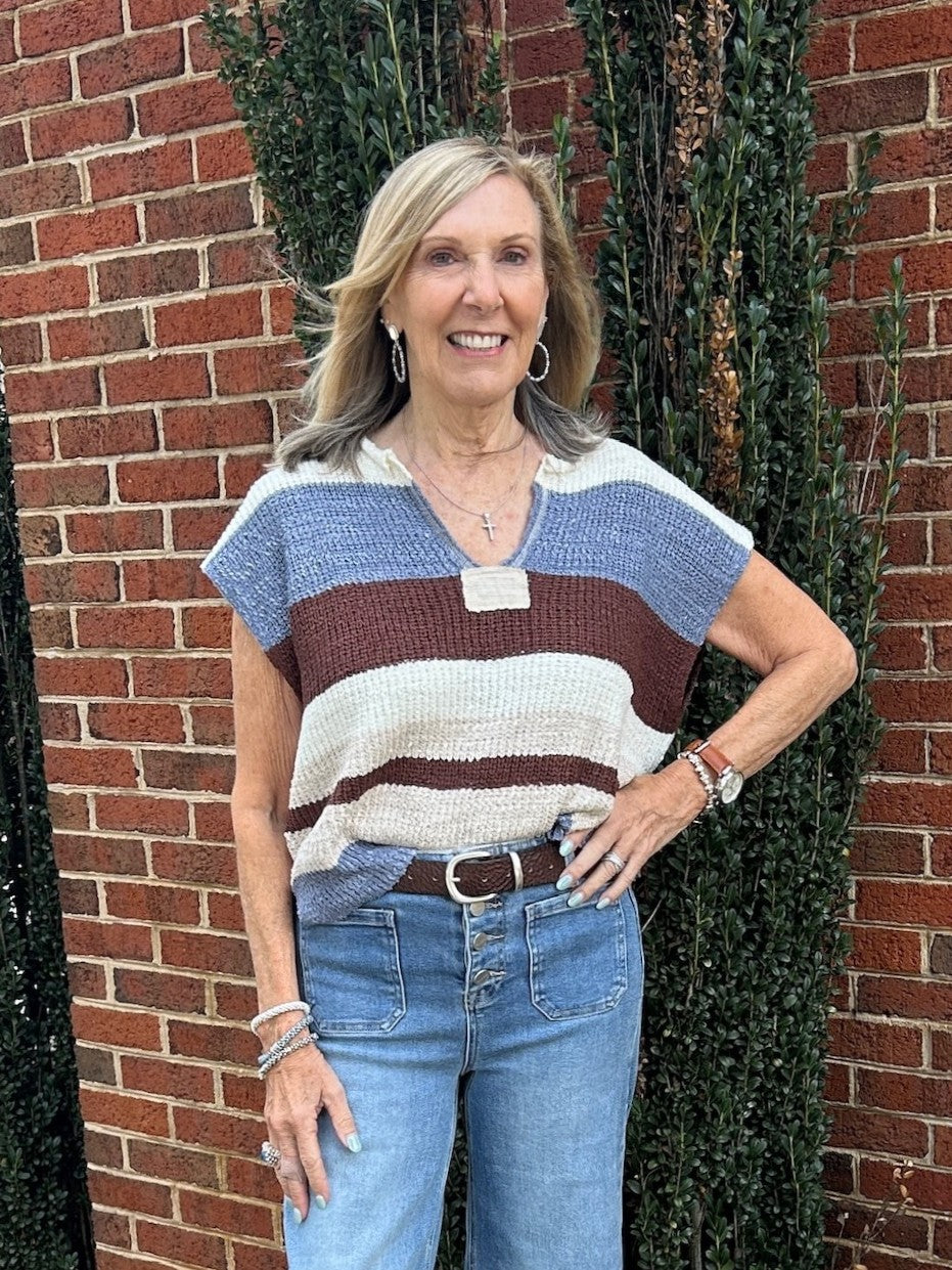 This lightweight Striped Cap Sleeve Sweater in a stunning frosted mocha color blends comfort and style effortlessly. Featuring a chic color block and striped design, it adds a modern touch to any outfit. The cap sleeves provide a delicate, flattering fit, making it an ideal layering piece. Perfect for transitioning between seasons, this sweater is a versatile addition to your wardrobe.

Pam is wearing a size Small. She paired the top with our "Risen High Rise Wide Cuffed Jeans".

Material: 70% Acrylic / 30%