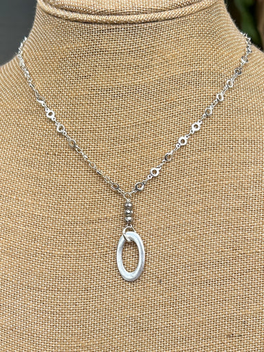 Accessorize with a unique statement piece. This 18-20" silver chain necklace is made with stylish & unique chain links and an oval drop. Stand out from the crowd with this beautiful necklace.