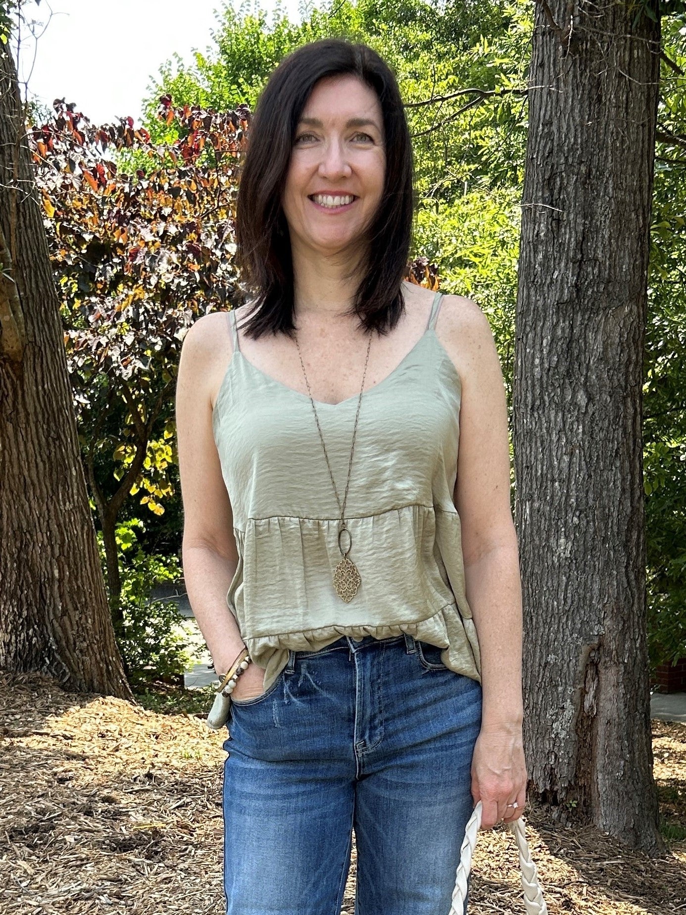 This spaghetti strap top features a delightful tiered bodice and a flowy silhouette, perfect for adding a graceful element to any wardrobe. Crafted in beautiful black and sage colors, this top is sure to be a favorite.  Material: 100% Polyester  Care Instructions: Hand wash cold, line dry