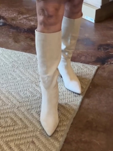 The Fern Tall Heeled Boot in a natural color offers a sleek, pointed toe design crafted from soft faux suede. These tall boots bring a stylish yet easygoing look that effortlessly complements any outfit. Their versatile style makes them ideal for both casual and dressy occasions, while providing all-day comfort.

Details:

Faux suede

Wood heel

Zipper closure