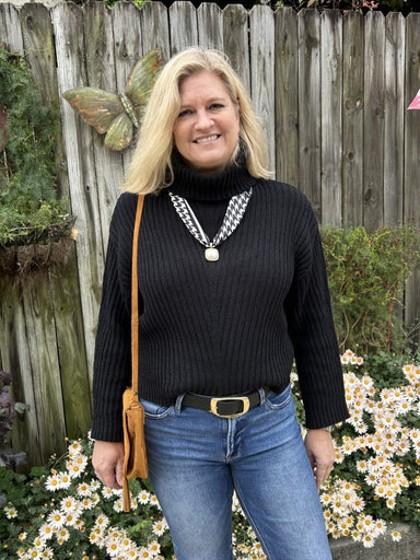 This black turtleneck sweater is the foundation piece every wardrobe needs. Its textured weave adds dimension and interest while the classic silhouette keeps it endlessly wearable. Layer it under blazers, cardigans, or jackets for instant polish, or wear it standalone for effortless sophistication. The versatile black colorway pairs with everything in your closet, making it the go-to choice for building cohesive, stylish outfits season after season.

Material: 100% Polyester

Care Instructions: Hand wash co