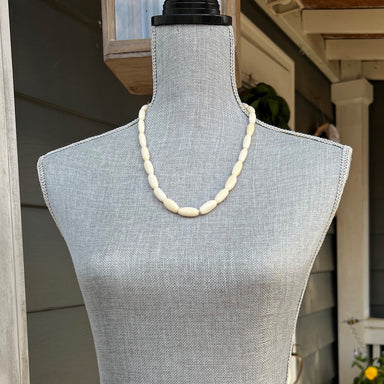 This luxurious necklace is handcrafted with camel bone beads. The beads have an oblong shape giving the necklace a unique look. The sophisticated materials make this necklace an exquisite addition to any wardrobe. The approximate length is 23".