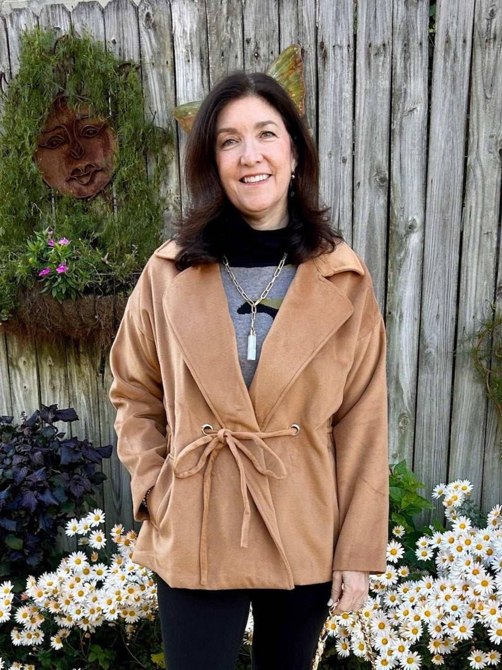 This camel-colored coat features a classic collar and a stylish tie waist, creating a flattering silhouette. Crafted from a very soft fabric, it offers both comfort and a luxurious feel. Its trendy short cut makes it a versatile piece that pairs effortlessly with any outfit, while the warm neutral tone ensures timeless elegance.

Material: 100% Polyester

Care Instructions: Hand wash on cold water, lay flat to dry