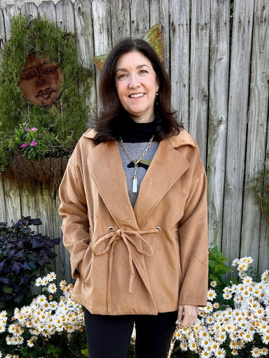 This camel-colored coat features a classic collar and a stylish tie waist, creating a flattering silhouette. Crafted from a very soft fabric, it offers both comfort and a luxurious feel. Its trendy short cut makes it a versatile piece that pairs effortlessly with any outfit, while the warm neutral tone ensures timeless elegance.

Material: 100% Polyester

Care Instructions: Hand wash on cold water, lay flat to dry