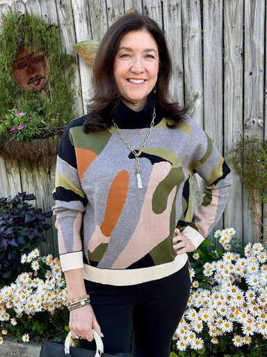 Discover the perfect blend of style and comfort with this color block turtleneck sweater. Its eye-catching geometric design showcases a gray canvas punctuated by fall's most flattering shades—black, olive, rust, beige, and cream—creating a look that's both modern and seasonally relevant. The plush, touchable fabric feels as good as it looks, while the classic turtleneck and long sleeves offer warmth without bulk. Whether you're heading to the office or weekend brunch, this sweater delivers sophisticated ver