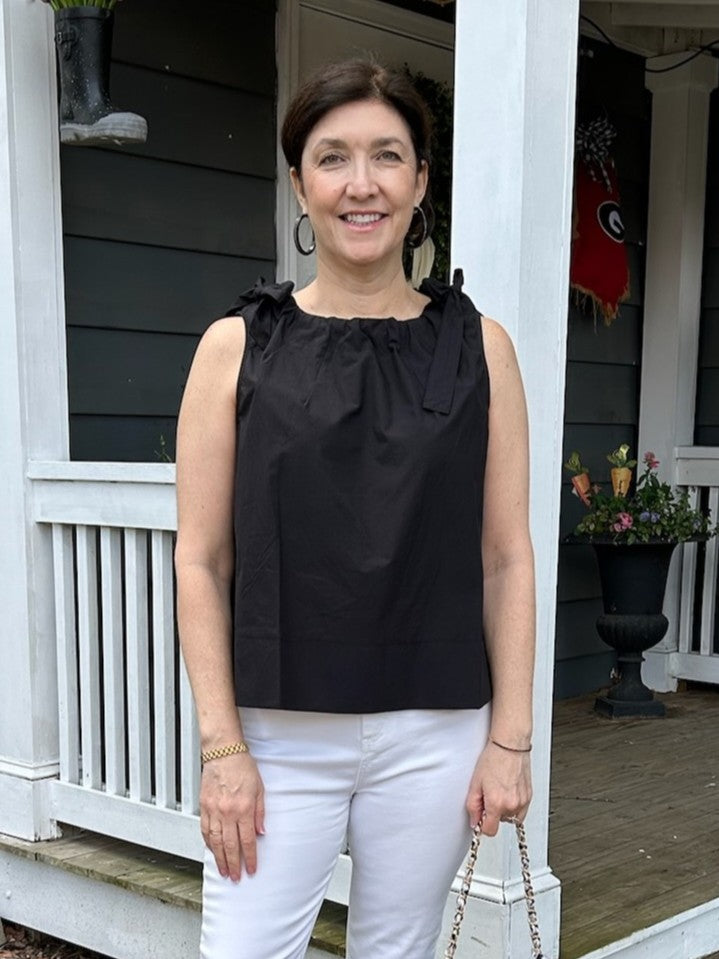 This sleeveless top features charming shoulder ties that add a playful touch to your outfit. Its versatile design makes it perfect for both casual days and dressier occasions. A stylish staple that effortlessly elevates your wardrobe.

Material: 100% Cotton

Care Instructions: Hand wash cold, do not tumble dry