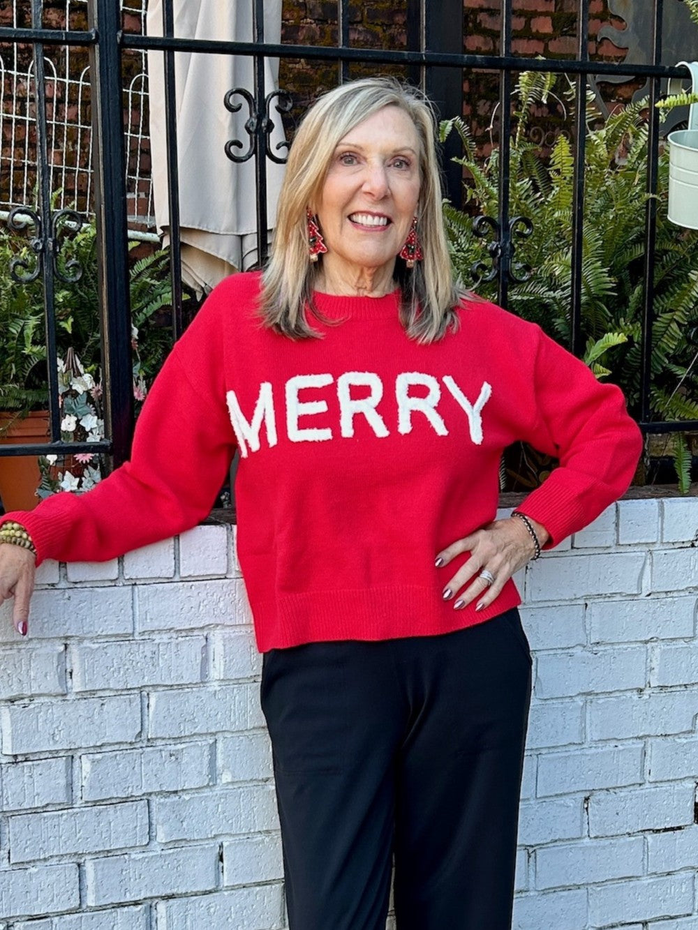 Spread holiday cheer in this vibrant red Christmas sweater featuring playful puffy letters spelling "Merry." The tactile, dimensional lettering adds a fun, festive touch that captures the spirit of the season. Perfect for holiday parties, family gatherings, or cozy winter days, this sweater combines comfort with eye-catching style. Whether you're decorating the halls or just want to wear your seasonal spirit, this cheerful piece brings instant joy and warmth to your wardrobe.

Material: 39% Acrylic / 31% Po