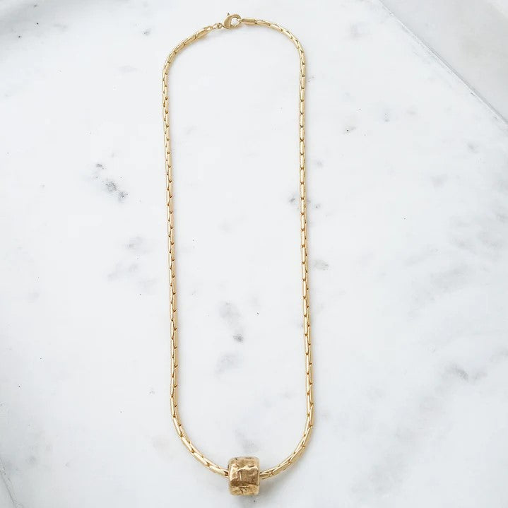 Enhance your everyday look with this beautiful Interlinking Chain Necklace with a stylish hammered tube charm. Delicate and elegant, this necklace will add a touch of sophistication to any outfit. Feel confident and inspired wearing this stunning accessory!  18” Chain 