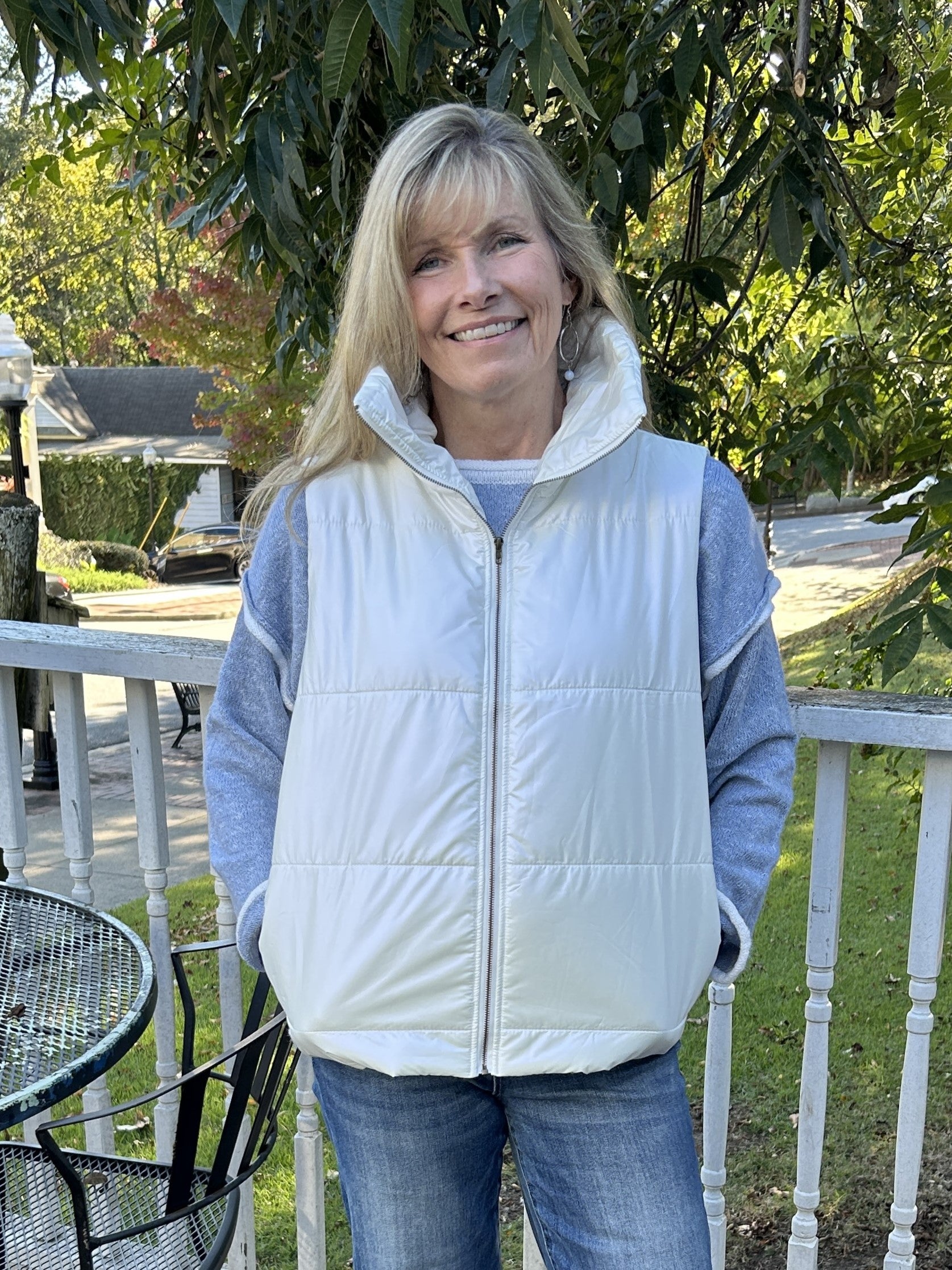 Stay warm and look stylish in this Ivory Puffer Vest! This beautiful cream-colored vest has a sheen, front zip closure, convenient side pockets, and a fold-over or stand-up collar. Up your fashion game with this cozy and versatile piece.   Material: 100% Polyester; Lining 100% Polyester  Care Instructions: Hand wash cold, 