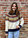 A timeless knit sweater perfect for cooler weather. This piece features a classic cream base with vibrant traditional Fair Isle patterning accent, blending warm fall color accents for an effortlessly polished look. The cozy construction makes it ideal for layering or wearing standalone. A versatile wardrobe essential!

Material: 60% Acrylic / 19% Polyester / 19% Nylon / 2% Spandex

Care Instructions: Hand wash with cold water, line dry