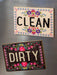 Keep your dishwasher organized with this charming double-sided magnet. Flip it to show whether your dishes are clean or dirty at a glance. Features elegant gold edge foil detailing and works with most magnetic dishwashers. A practical and stylish kitchen essential that adds a touch of personality to your appliance.

Dimensions:&nbsp;4in L x 2.78in W

Material:&nbsp; Wood