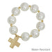 Large pearl beads create a striking statement, complemented by a delicate hammered cross charm. The stretch design slips on effortlessly for everyday wear or special occasions.