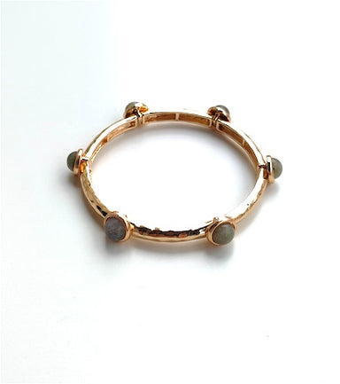 This gold stretch bracelet combines understated beauty with practical comfort. Gray stones provide a sophisticated neutral tone that pairs effortlessly with any ensemble, while the flexible design adapts to your wrist for all-day wear. A refined accessory that bridges casual and polished styles with quiet grace.