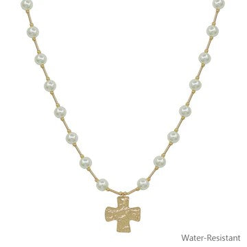 Make a graceful statement with this beautifully crafted beaded necklace, anchored by a mesmerizing hammered cross that commands attention. Artfully spaced tube beads alternate the beads, adding texture and visual intrigue that elevates your look instantly. The cross's distinctive hammered finish brings authentic character and depth. Versatile enough for everyday elegance or special occasions.

Length: 16-18"
