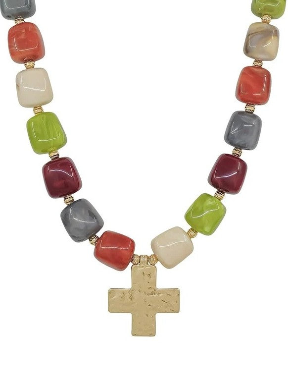 Radiant multi-color resin beads in warm jewel tones create instant visual impact on this 16 mm beaded necklace. A textured cross charm anchors the design with spiritual significance and refined elegance. This versatile necklace adds depth and personality to your everyday look.&nbsp;

Length: 18"