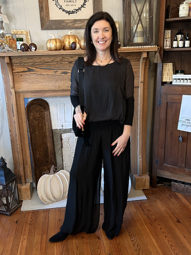 Step into the holiday season in style with our Madelyn Silky Pants. The lightweight silk fabric and lined interior combine with a banded, stretch waist and elegant flowy legs for a relaxed-yet-polished look. They can be perfectly paired with any of our Cobblestone tops. Additionally, these black pants will coordinate well with so many tops!  Details:  One size fits most 70% Viscose / 30% Seta (made from silk) Hand wash, lay flat or hang to dry Made in Italy
