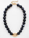 Timeless elegance meets natural beauty in this Black Natural Stone Beaded Necklace. Strung with smooth 8mm black stone beads, it features a striking gold-centered charm that adds refined sophistication to any look. The earthy appeal of natural stone pairs perfectly with the warm gleam of gold, creating a piece that works beautifully layered or worn alone. Effortlessly versatile, it transitions from casual daytime wear to evening sophistication with ease.

Length: 16-18"