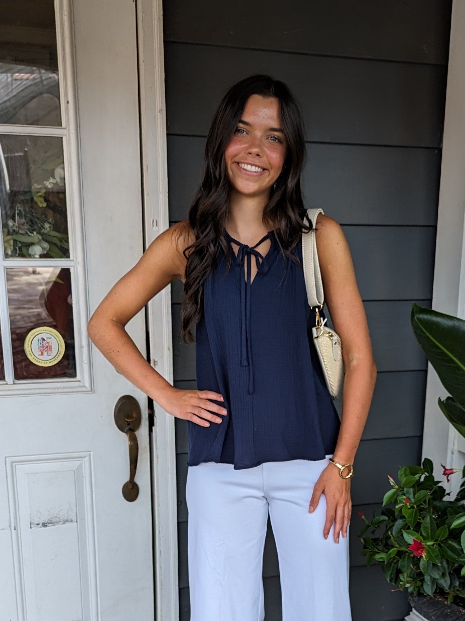 The Tulip Back Halter Top is perfect for the spring and summer with its beautiful navy color, spaghetti straps and tie front. The cutest feature is its open wrap-around back, making it such an adorable top!  Material: 100% Cotton  Care Instructions: Hand wash cold, line dry