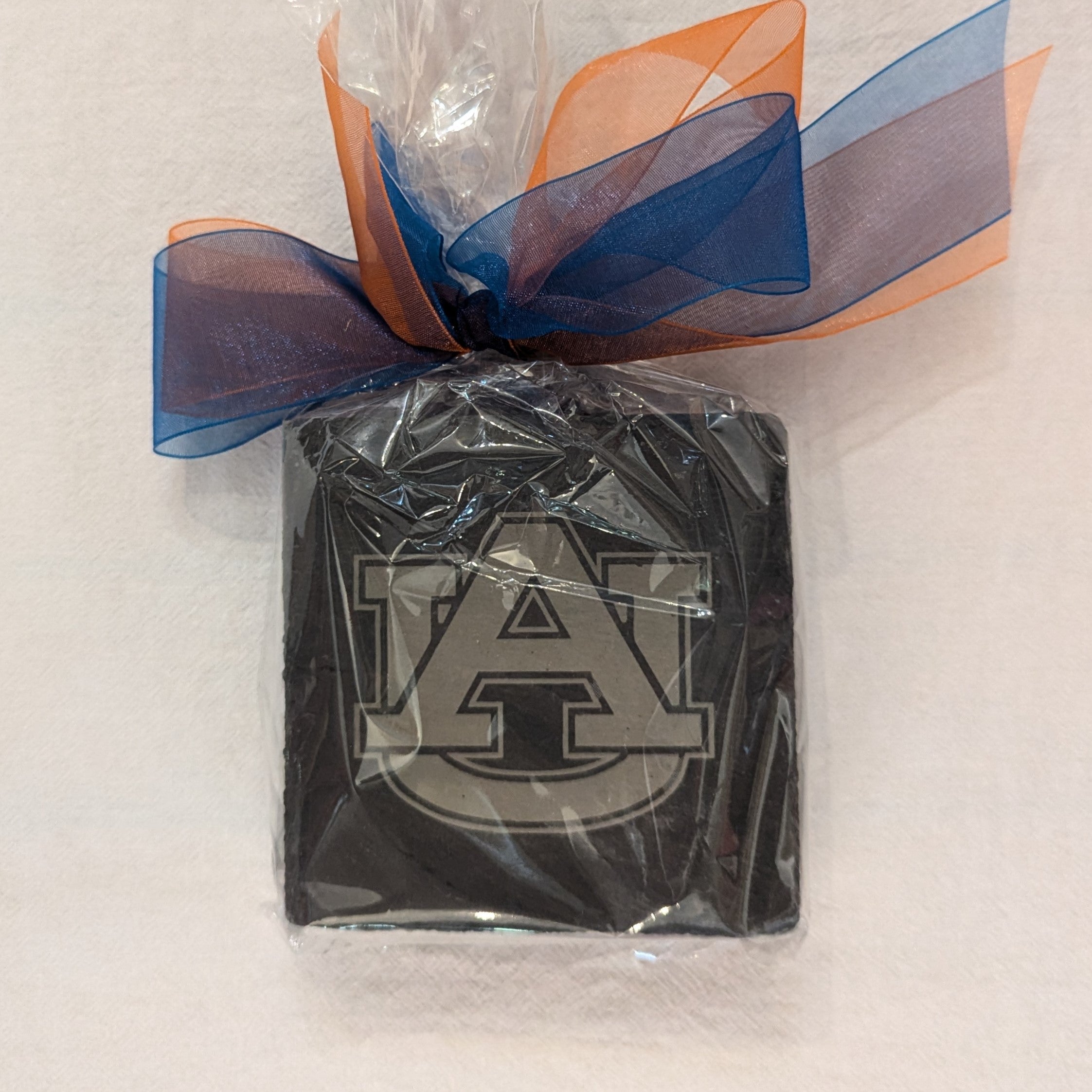 Add a touch of sophistication to your home with our Slate Coaster Set! Each coaster is delicately engraved and made of durable slate. With collegiate designs, it's the perfect gift for any college sports fan!  Set of 4 4" x 4" each