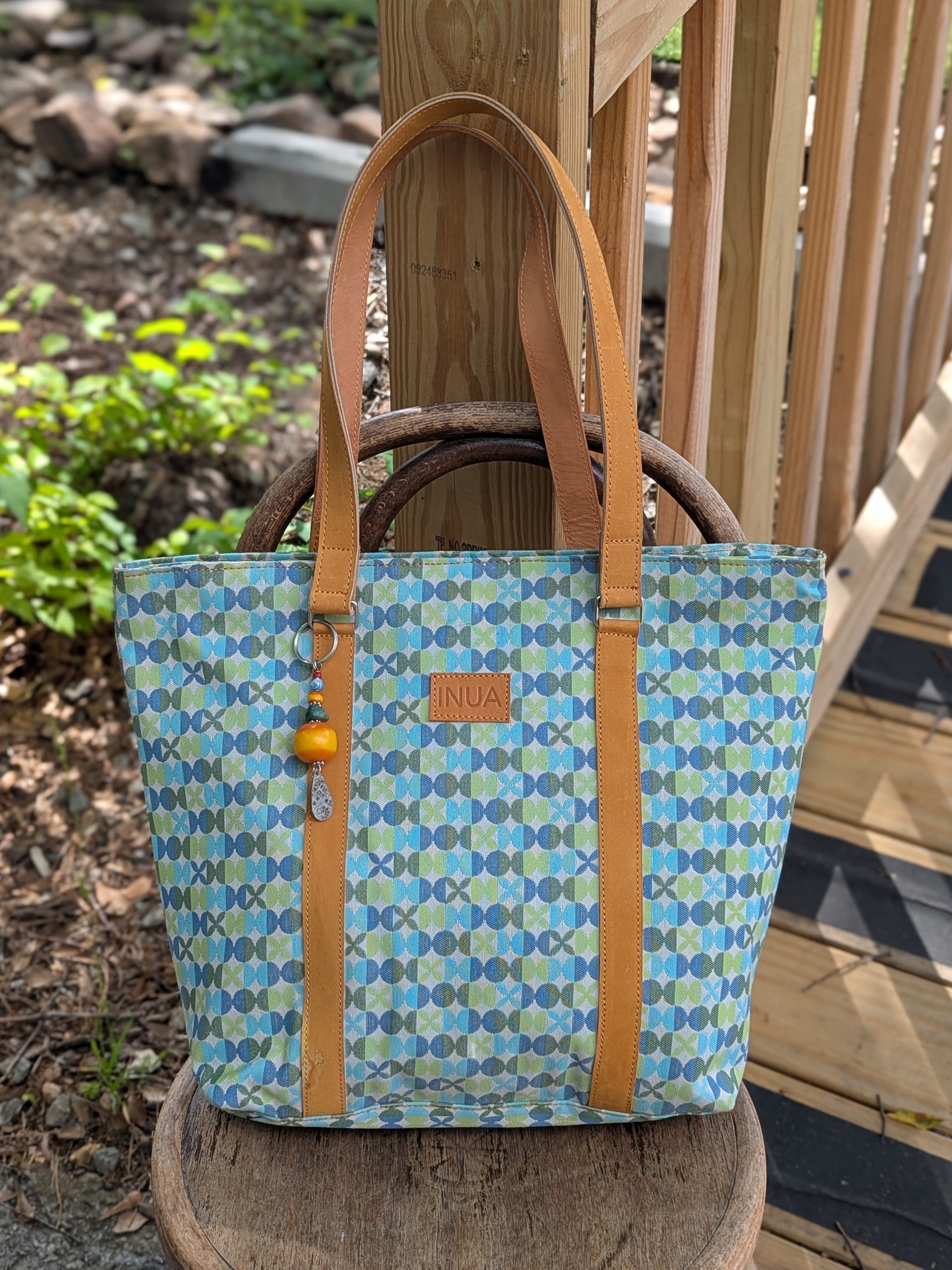 Carry your belongings with purpose and style with our Tote Bag - Crafted with Purpose! Made with durable upholstery material, adorned with a cute charm/keychain, inside zippered pocket and accented with leather straps, this bag not only supports a mission but also adds a touch of charm to your everyday look.

This bag is made by talented artisans in Kenya using upcycled upholstery fabric. Every purchase provides opportunities, empowers communities and creates sustainable livelihoods.

Carry more than a bag 