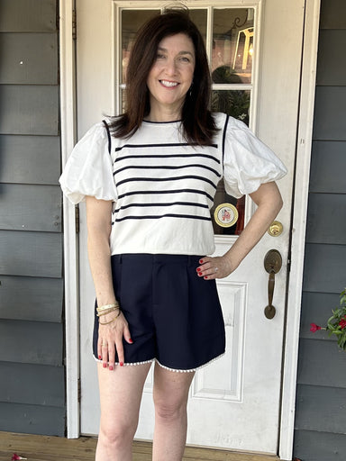 These Pearl Trimmed Navy Shorts are the perfect combination of style and elegance. The beautiful pearl hem adds a touch of sophistication, while the navy color and belt loops make them versatile and dressy. These are such lovely shorts - you will love them!  Pair with our beautiful "Puffed Sleeve Striped Knit Top".  Material: 100% Polyester  Care Instructions: Hand wash cold, flat dry