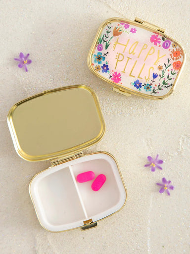 Keep your daily medications organized and accessible with this charming "Happy Pills" pill box holder. The compact design fits easily into purses, travel bags, or bathroom drawers, making it perfect for on-the-go lifestyles. An internal divider creates two separate compartments, allowing you to sort different medications or supplements with ease. The cute, thoughtful design transforms a practical necessity into something you'll actually enjoy using every day.

Dimensions: 2.25in L x 2in W x 1.25in H

Materi