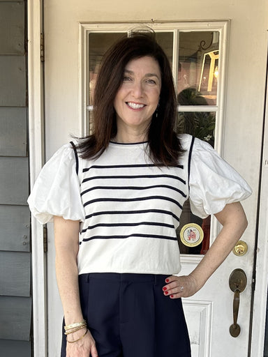 Chic and fun, our Puffed Sleeve Striped Knit Top is the perfect addition to your wardrobe! The lightweight ivory knit bodice features navy stripes, while cute puffy sleeves add a touch of playfulness. The banded waist creates a flattering silhouette and pairs perfectly with your favorite jeans or navy bottoms.  Pair with our beautiful "Pearl Trimmed Navy Shorts".  Material: 80% Viscose / 20% Nylon; Sleeves: 70% Cotton / 30% Linen  Care Instructions: Hand wash cold, flat dry